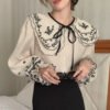 قميص فضفاض بأكمام جرس وطية صدر واحدة وصدر كبير
