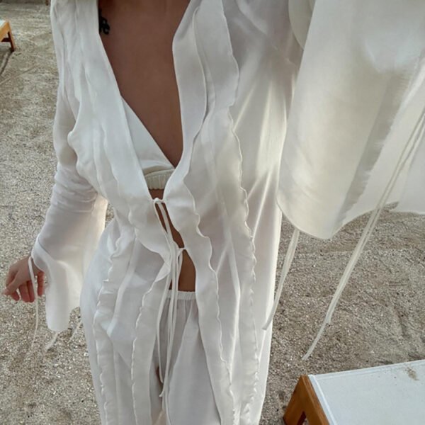 b5571daa-69d7-44d1-a180-ea0bbf6f80ee-1.jpg طقم مكون من قطعتين: بلوزة شفافة برباط أمامي وخصر محدد، وبنطال